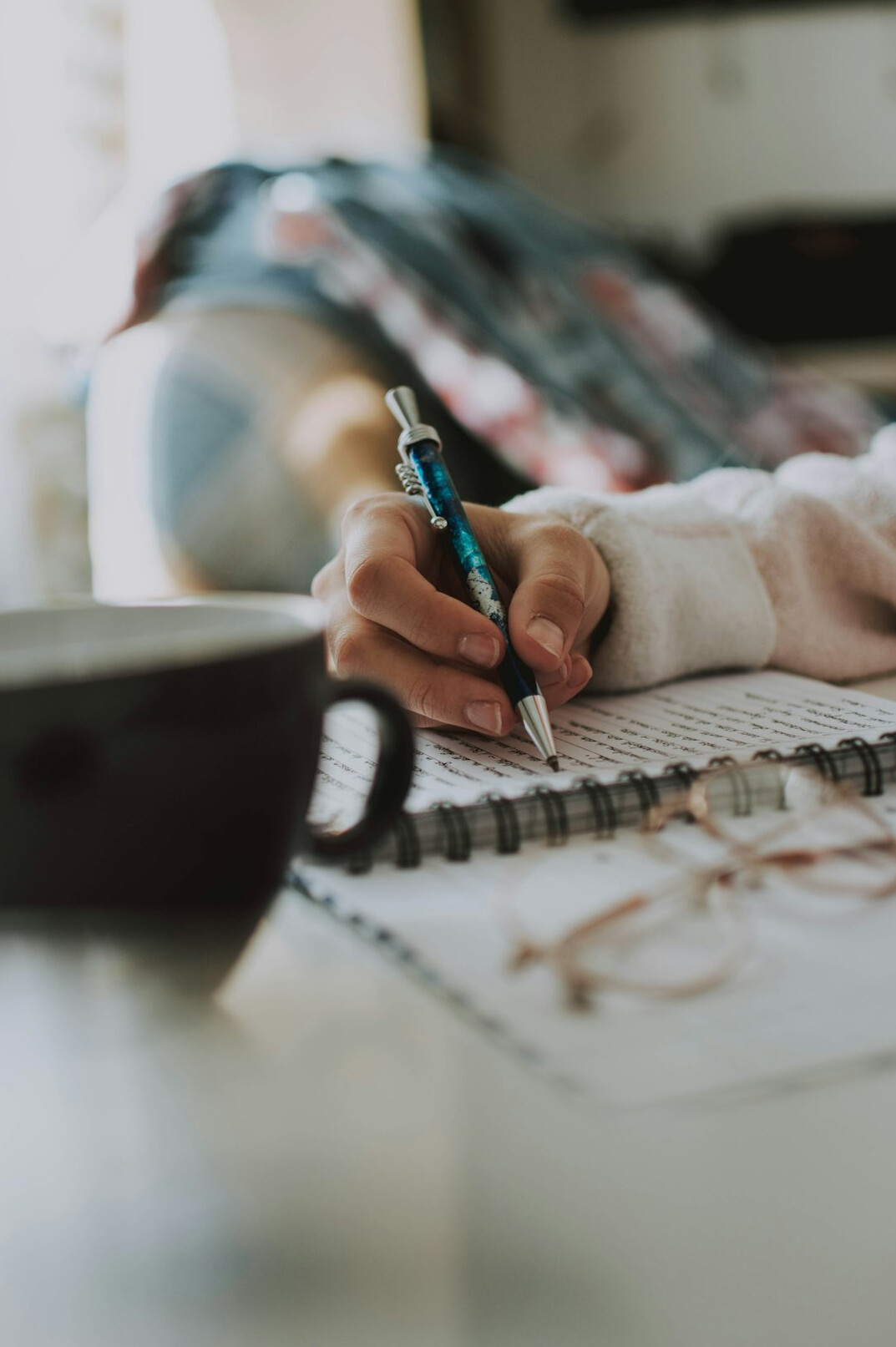 person writing in journal